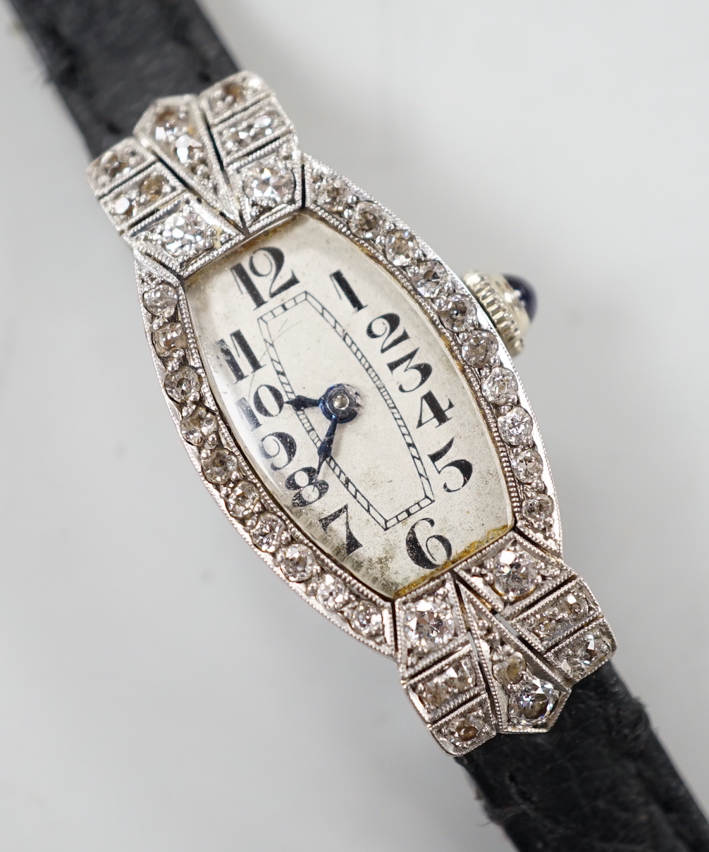 A lady's platine and diamond cluster set manual wind cocktail watch, on a leather strap.